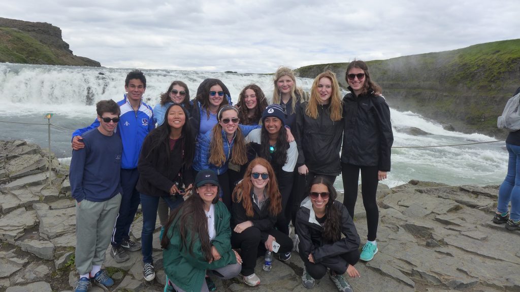 A whole group pose beside Gulfoss Falls.