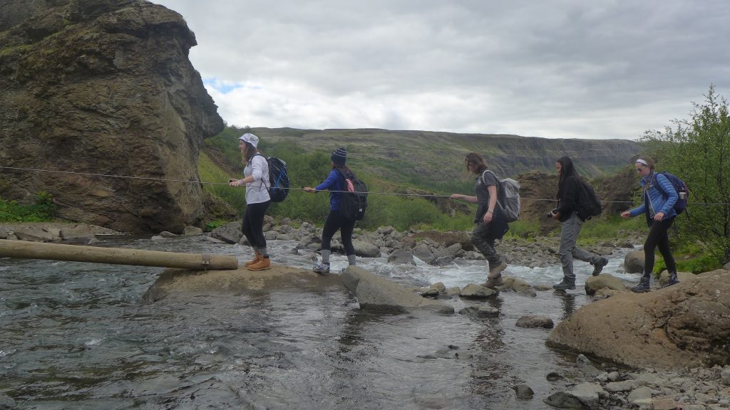 Crossing the waters below Glymur Waterfall.